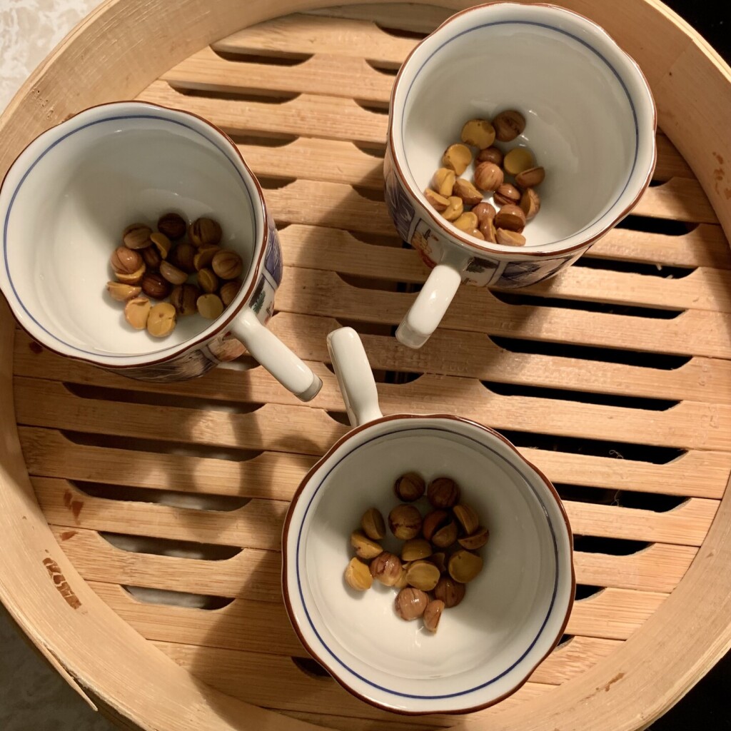This image is downward facing and shows the acorns sitting at the bottom of the little cups in the bamboo basket.  