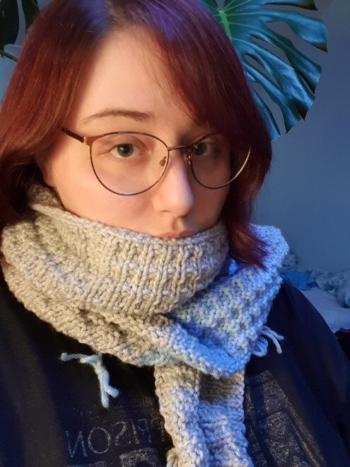 a selfie. i am wearing the top row of the blanket as a scarf. i look cute
