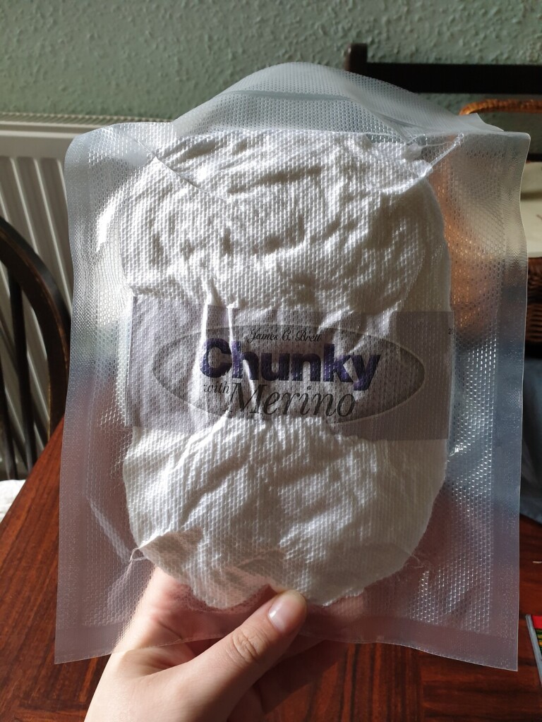 a flat white thing in a plastic package. it says 'chunky merino'