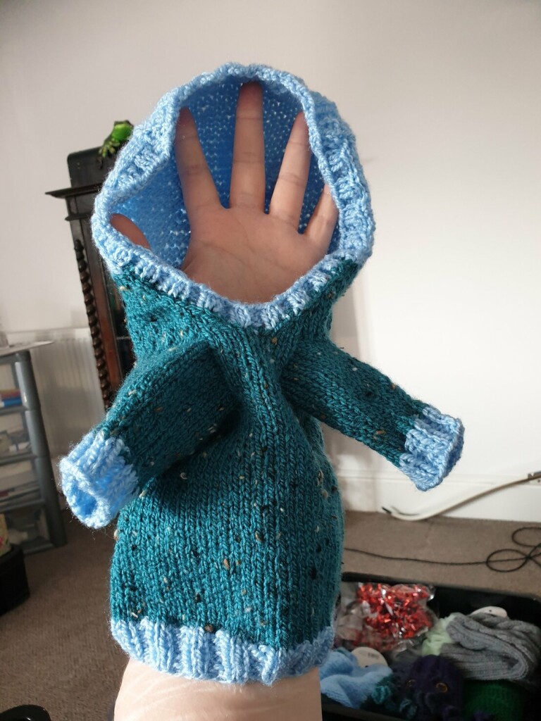 same design hoodie but this time the body and sleeves are dark teal and all the cuffs and the hood are light blue