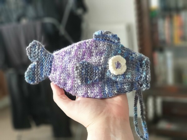 a purple and blue knitted fish bag