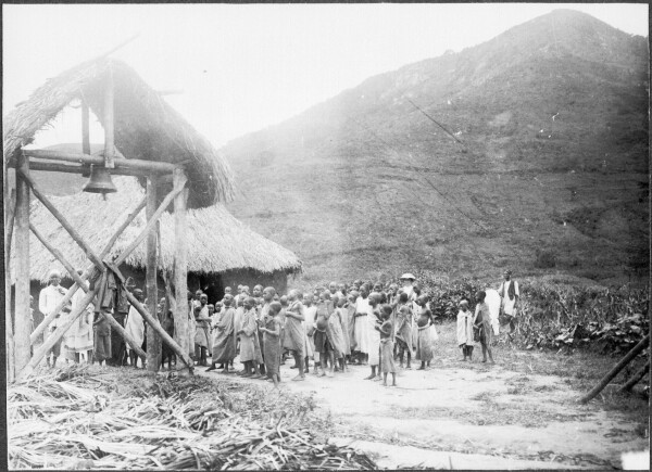 1913 Picture of new churchbells with hill in background in Chome (south pare mountains in Tanzania), showing a fairly denuded landscape with low grass/bush, no trees 

New church bell for Chome District, 1913. Unknown, Lutheran Leipzig Missionary Archives 5-611