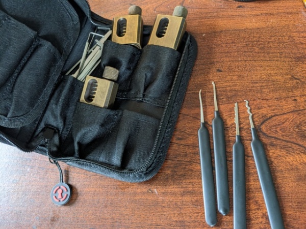 A lockpicking set, containing two picks, two rakes, a bunch of tension wrenches, and three brass (I think) practice locks